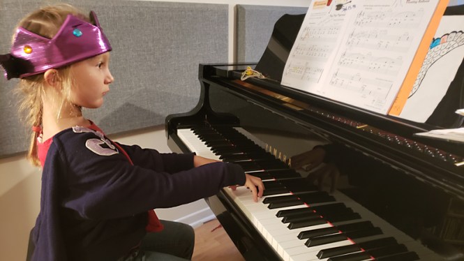 student taking piano lesson